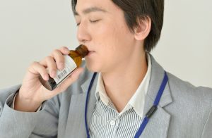 栄養ドリンクを飲む男性